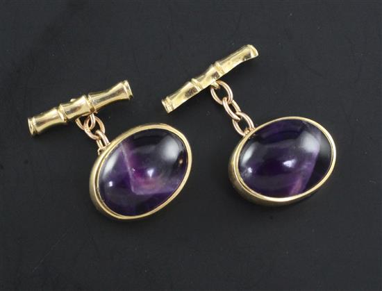 A pair of 1960s 9ct gold and oval cabochon amethyst set cufflinks.